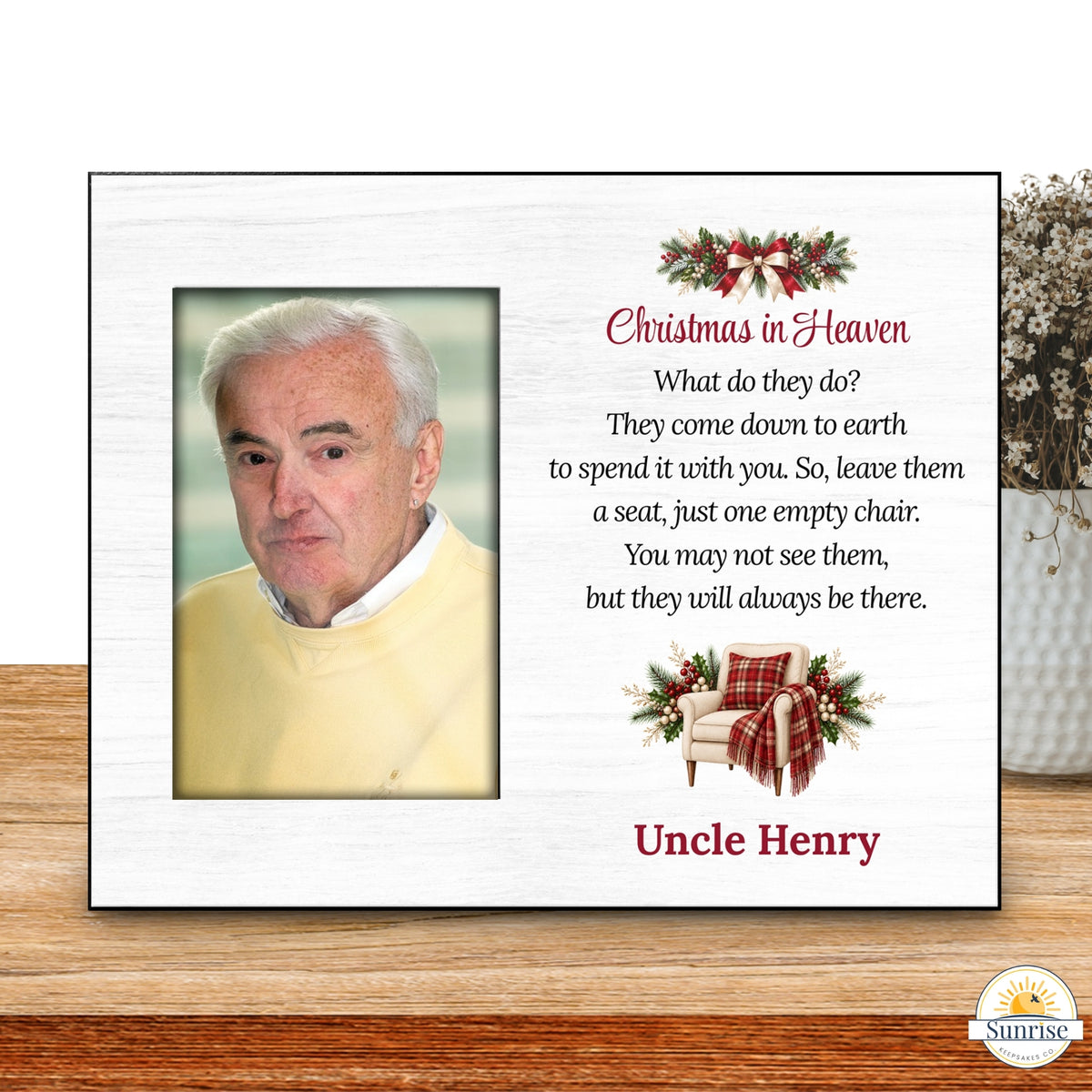 A personalized Christmas in Heaven memorial plaque displayed on a wooden surface. The white plaque features a photo of a man, a poem about heaven, and the name 'Uncle Henry' in red text, accented with red and green holiday graphics.