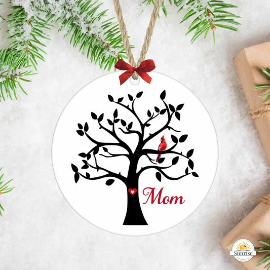 Decorative ornament with a tree design, 'Mom' text, and red birds on a white background.