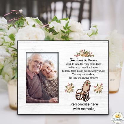 Memorial plaque with photo of an elderly couple and text about Christmas in Heaven, surrounded by flowers and a glass.