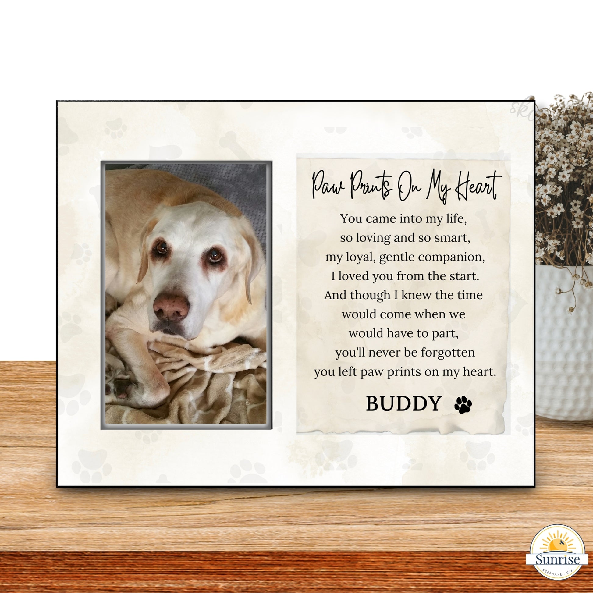 Framed picture of a dog with a heartfelt message on a wooden surface.