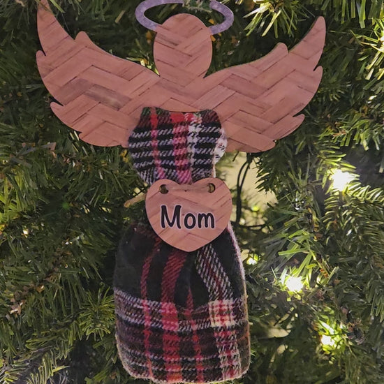 Angel wings with a printed pattern and glitter halo (not real glitter) holds fabric of a loved one