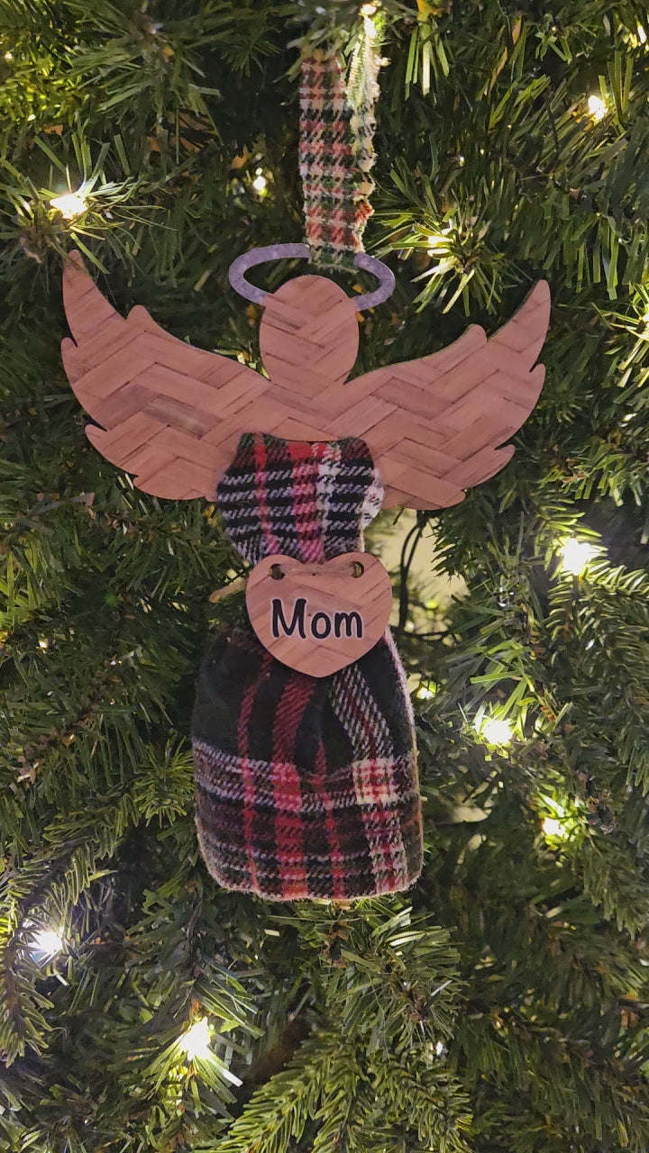 Angel wings with a printed pattern and glitter halo (not real glitter) holds fabric of a loved one