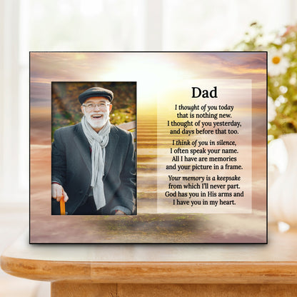 A personalized memorial plaque for Dad displayed on a wooden table. The plaque features a photo of a smiling elderly man on the left and a touching poem on the right, set against a sunset landscape background.